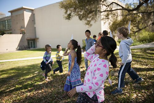 Campers throw paper planes. 