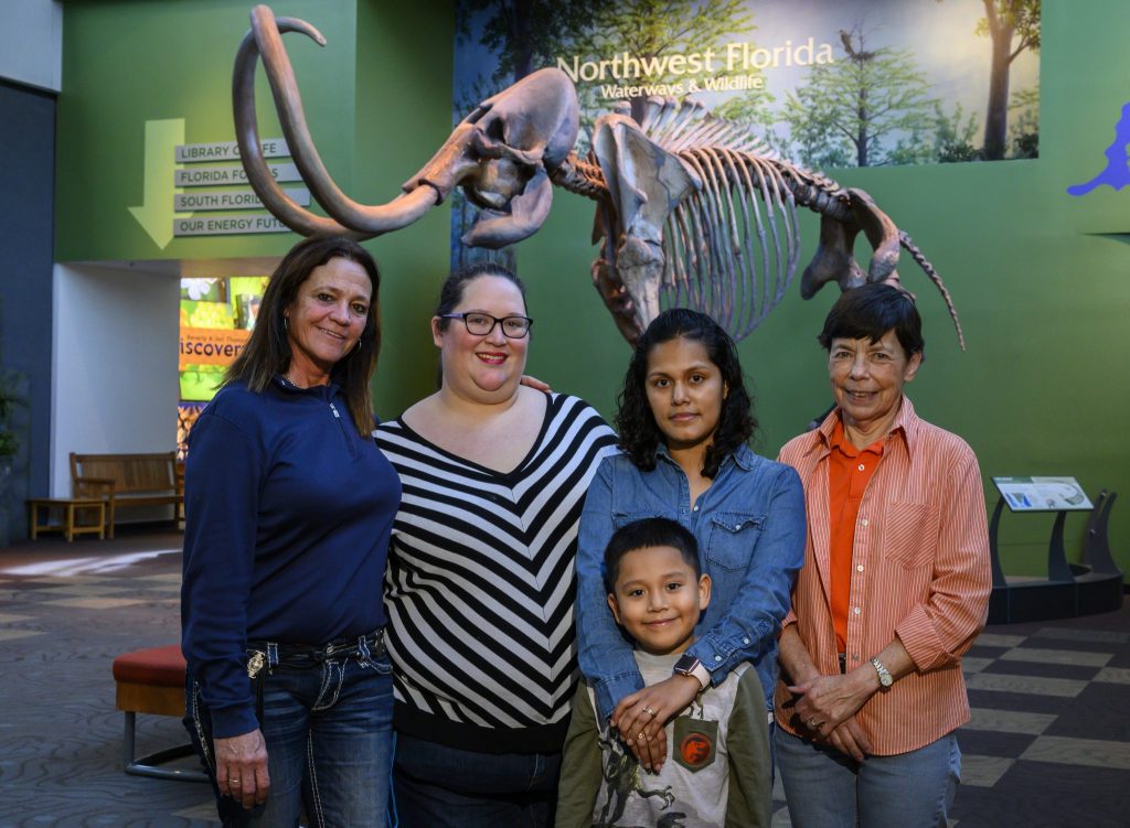 group standing in front of mammoth skeleton