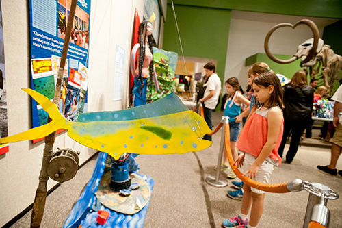 Visitors look at Trashformations entries.