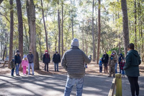 Group of people standing among trees