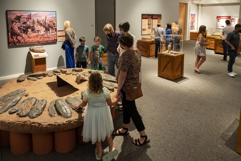 people walking around exhibit space