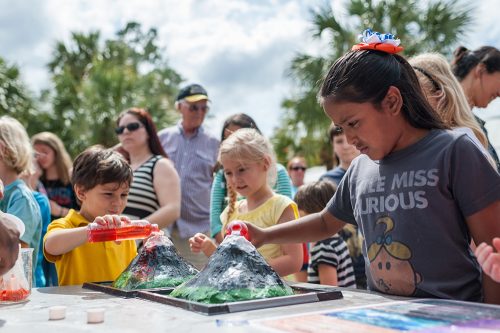 Kids playing with fake volcano demonstration