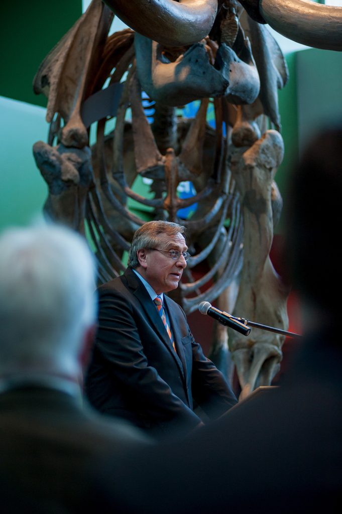President Fuchs addressing the gathering, the mammoth can be seen behind him