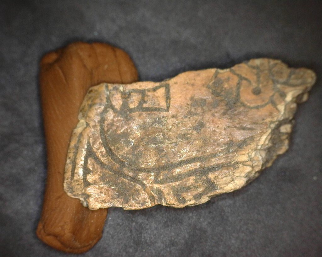 Carved bone fragment front