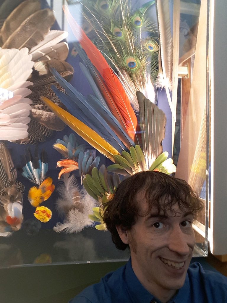 Graham selfie in front of long feathers