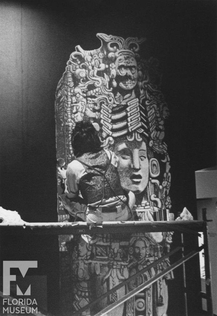 man painting Mayan stela