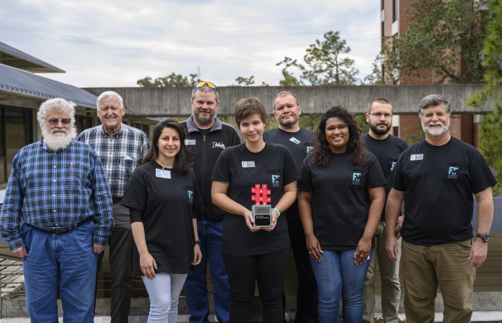 nine members of our invertebrate paleontology team