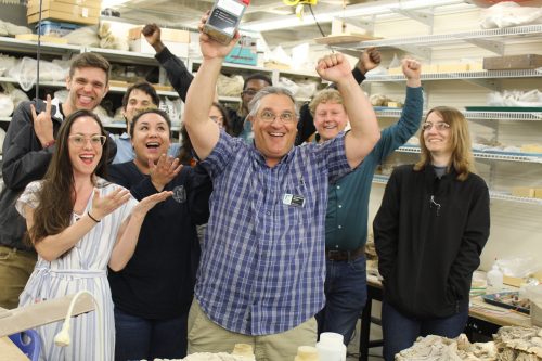 researchers and students being excited about an award