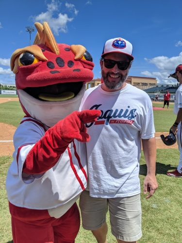 man with large amphibian sports mascot