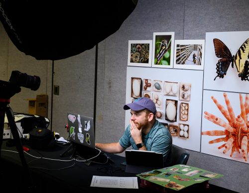 an educator in front of a computer in a digital classroom studio