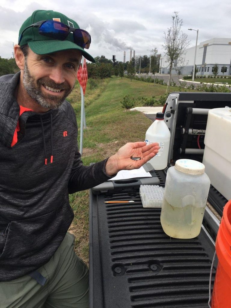 man holding fish in hand