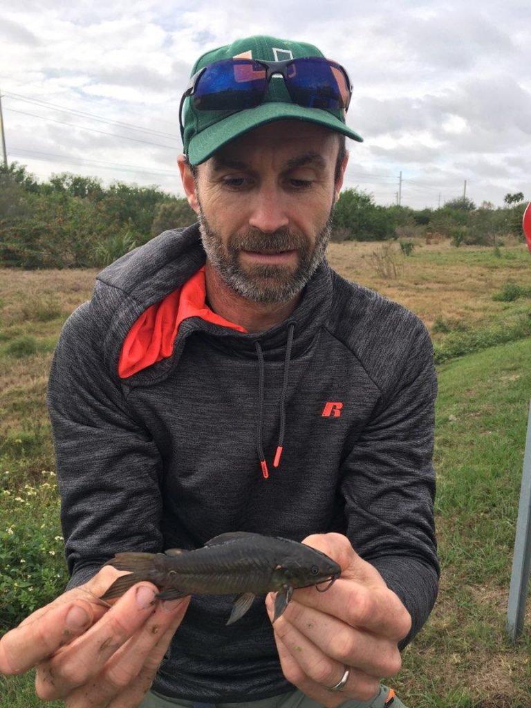 man holding fish with two hands