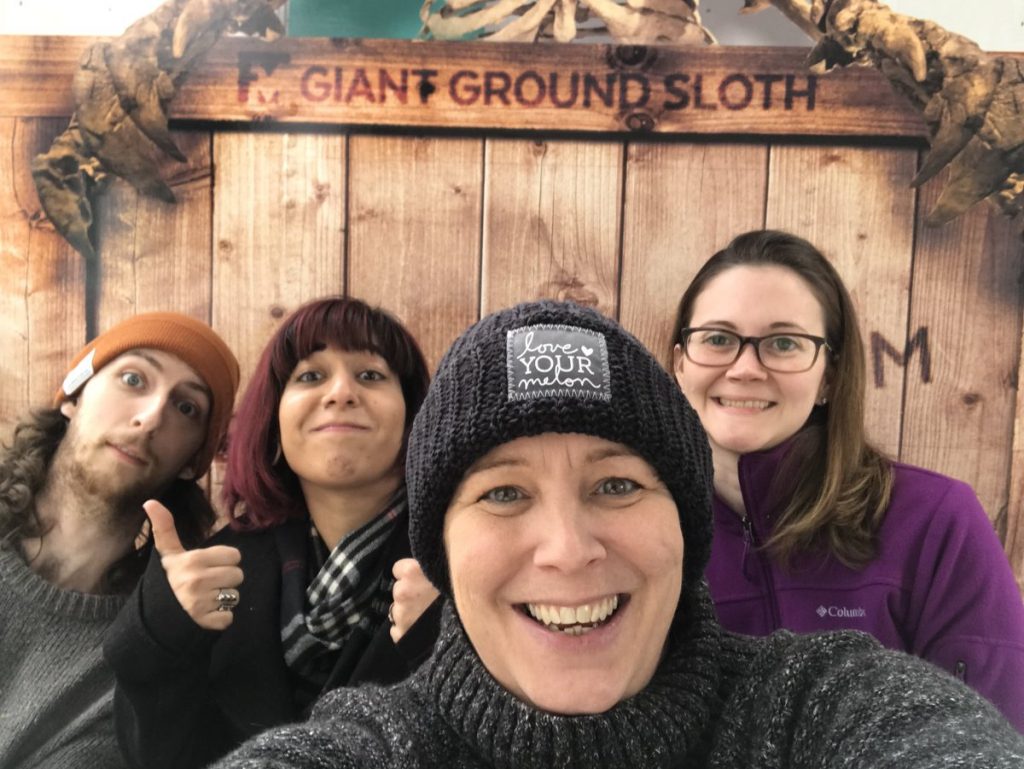 group selfie infront of Giant Grownd Sloth display