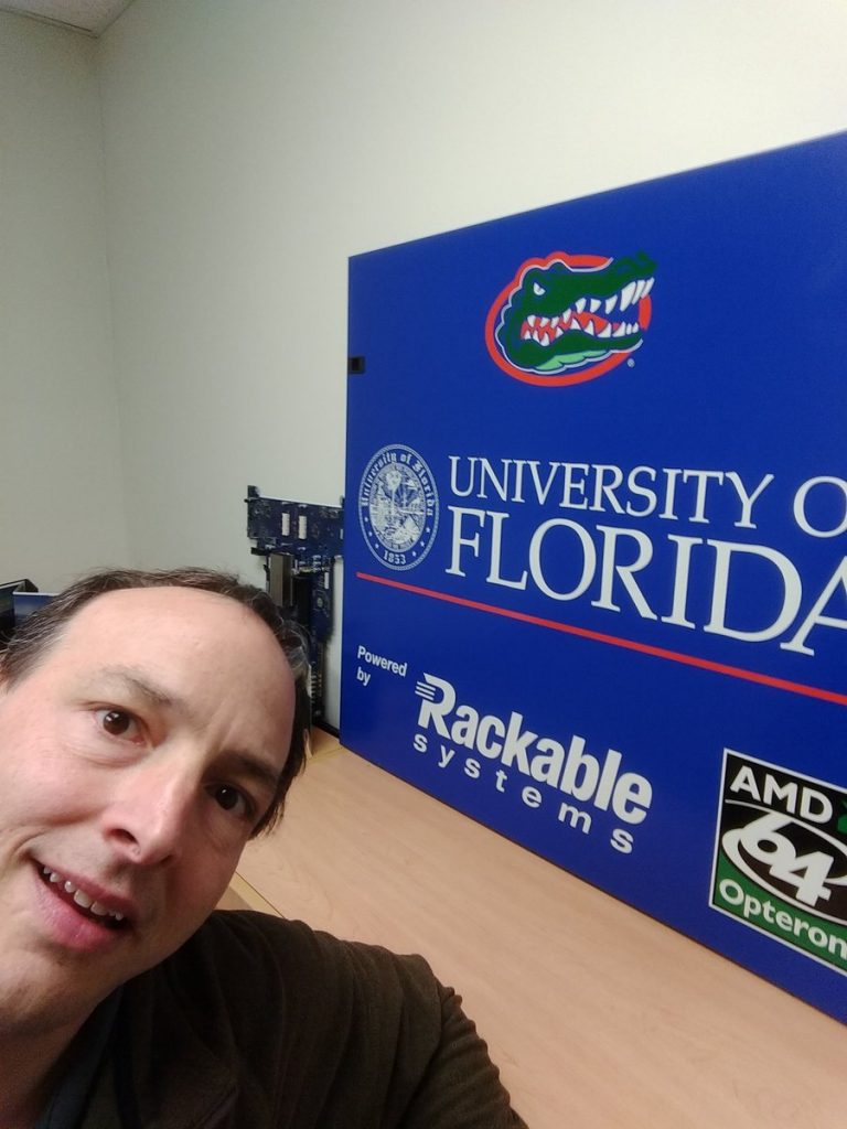 Matt selfie with with University of Florida banner behind him