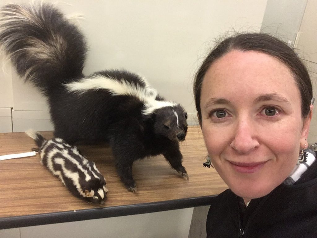 Verity selfie with skunk specimens