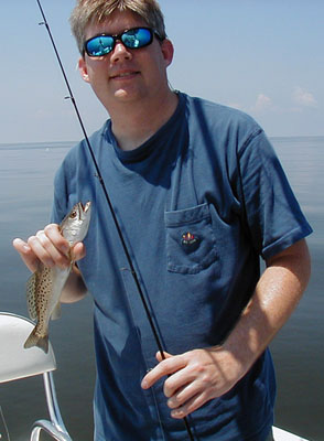 Recreational fisherman with spotted seatrout catch. Photo © Sean Morey