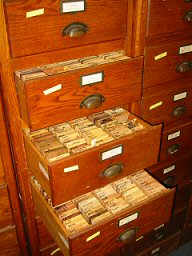 wooden drawers, the drawers are open showing the wood samples organized inside