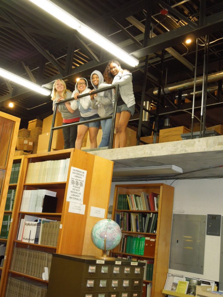 students and researchers standing on 2nd story of herbarium