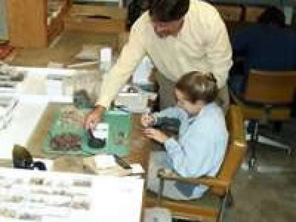 UF student Shanna Schofield working to separate, repackage, and relabel artifacts for long-term curation