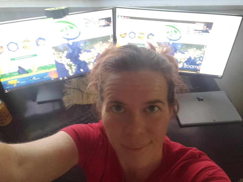 selfie in front of two computer monitors