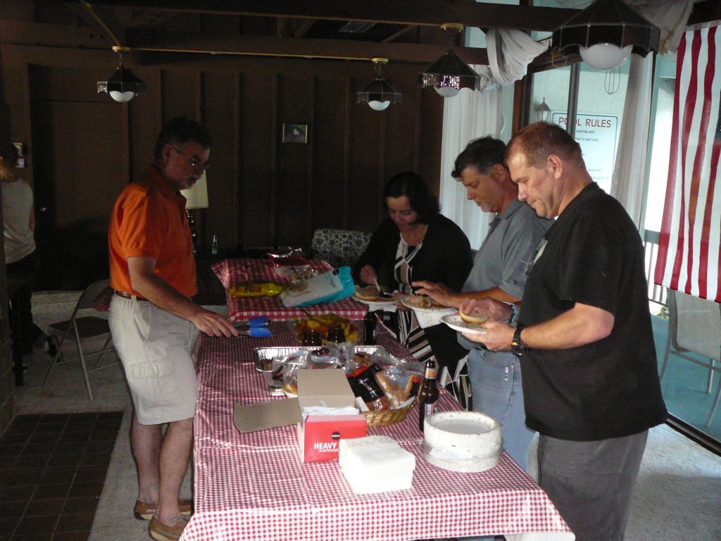 Bruce MacFadden serves BBQ meat to Dena Smith, Roger Portell, and Michal Kowalewski at the Paleo Potluck Party held as part of Dena Smith’s visit to the Florida Museum of Natural History. Photo by Adiel Klompmaker.
