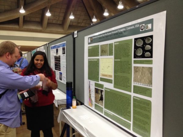 Dipa Desai explaining her work with ostracods to a GSA attendee.