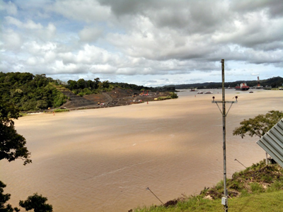 A view of the new cuts just across from Gamboa, on the west side of the canal. In the background of the picture, you can see the dredging occurring as well as a ship passing through. Photo courtesy of Dipa Desai.