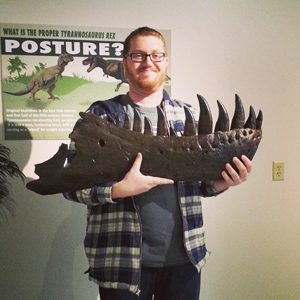 Ian holding the jaw of Tyrannosaurus rex at the University of Wyoming Museum. Photo courtesy of Ian Cannon.