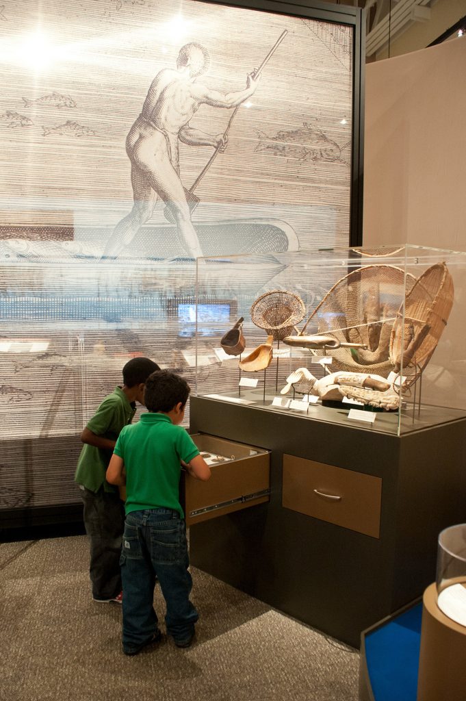 two young children looking at exhibit