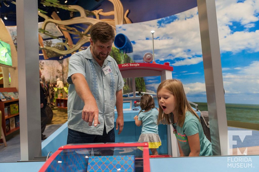 father and child exploring the exhibit