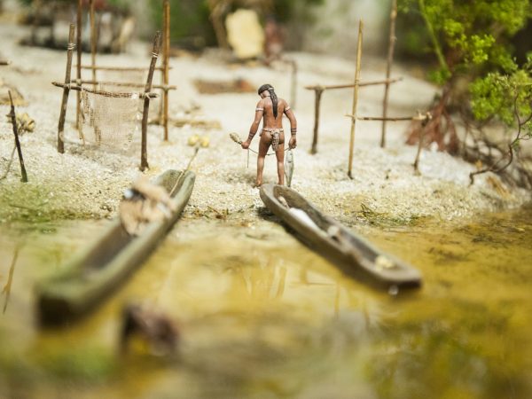 diorama showing native fisher returning from the water