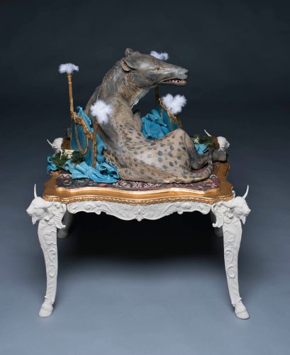 sculpture of an Andrewsarchus sitting on a crushed gold and blue four poster bed