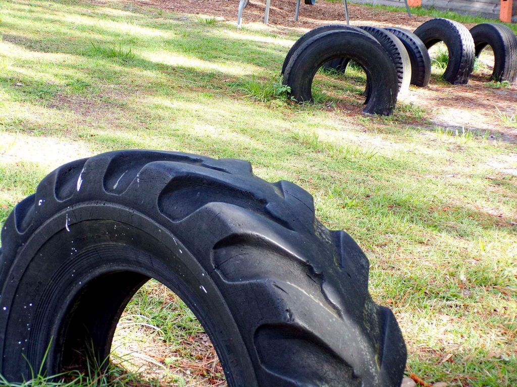 large tires buried half in the ground