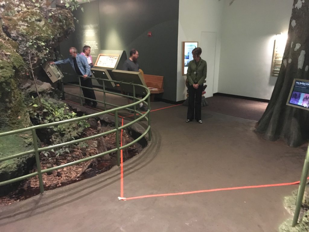 museum exhibit with lines marked off with orange tape