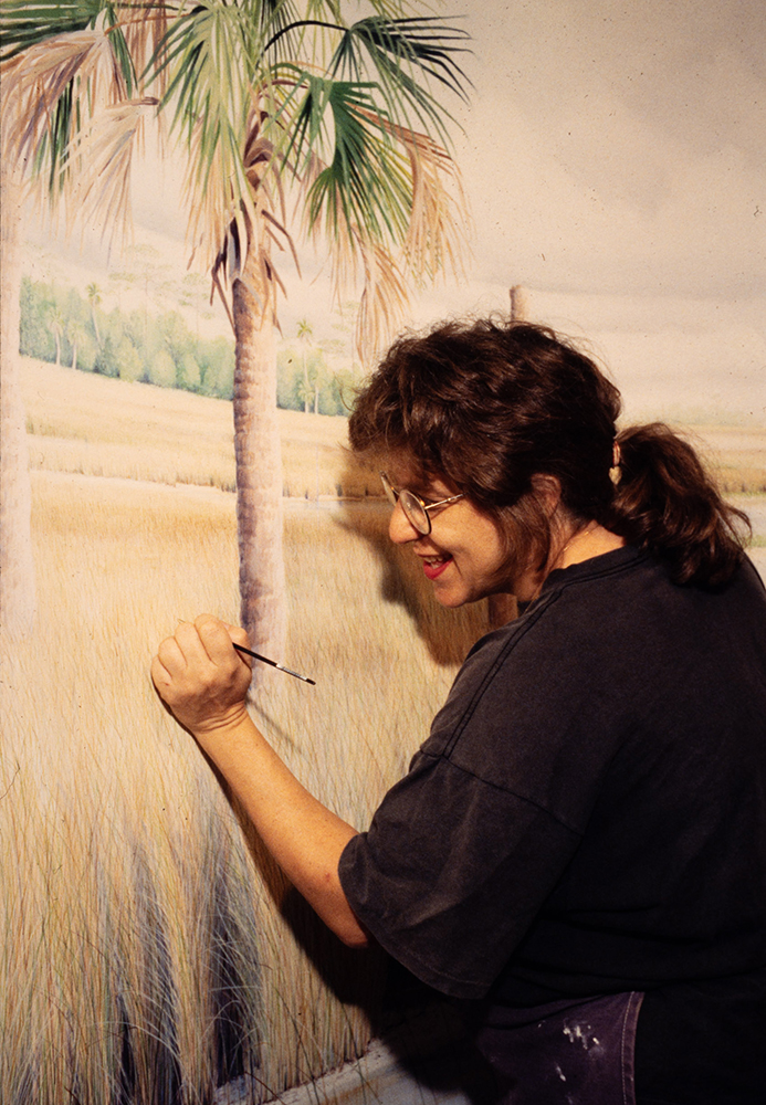 Woman painting a mural