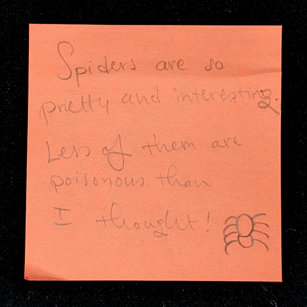 orange post-it note with handwritten note