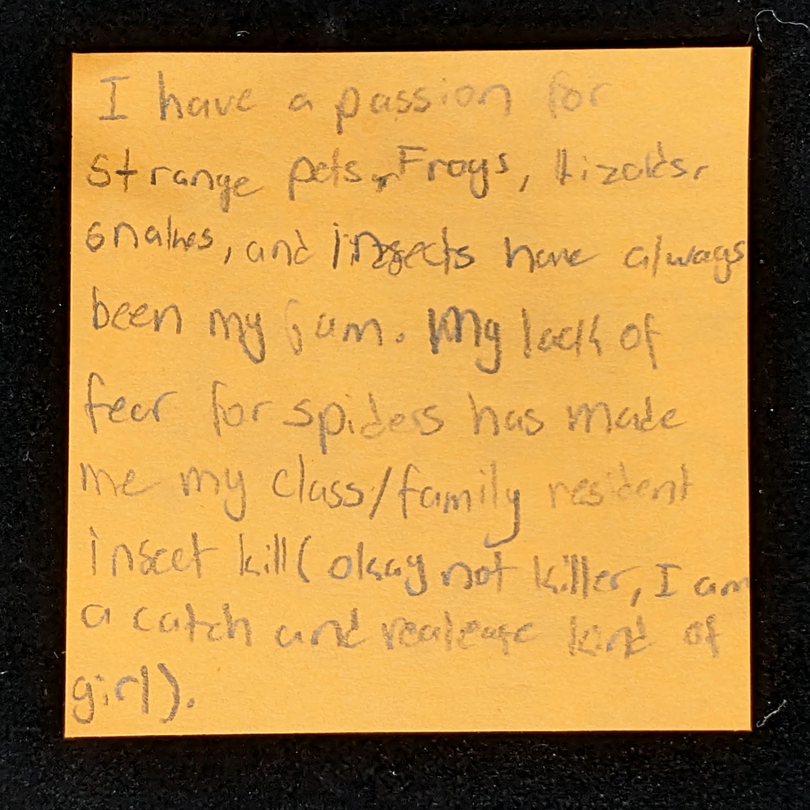 orange post-it note with handwritten note