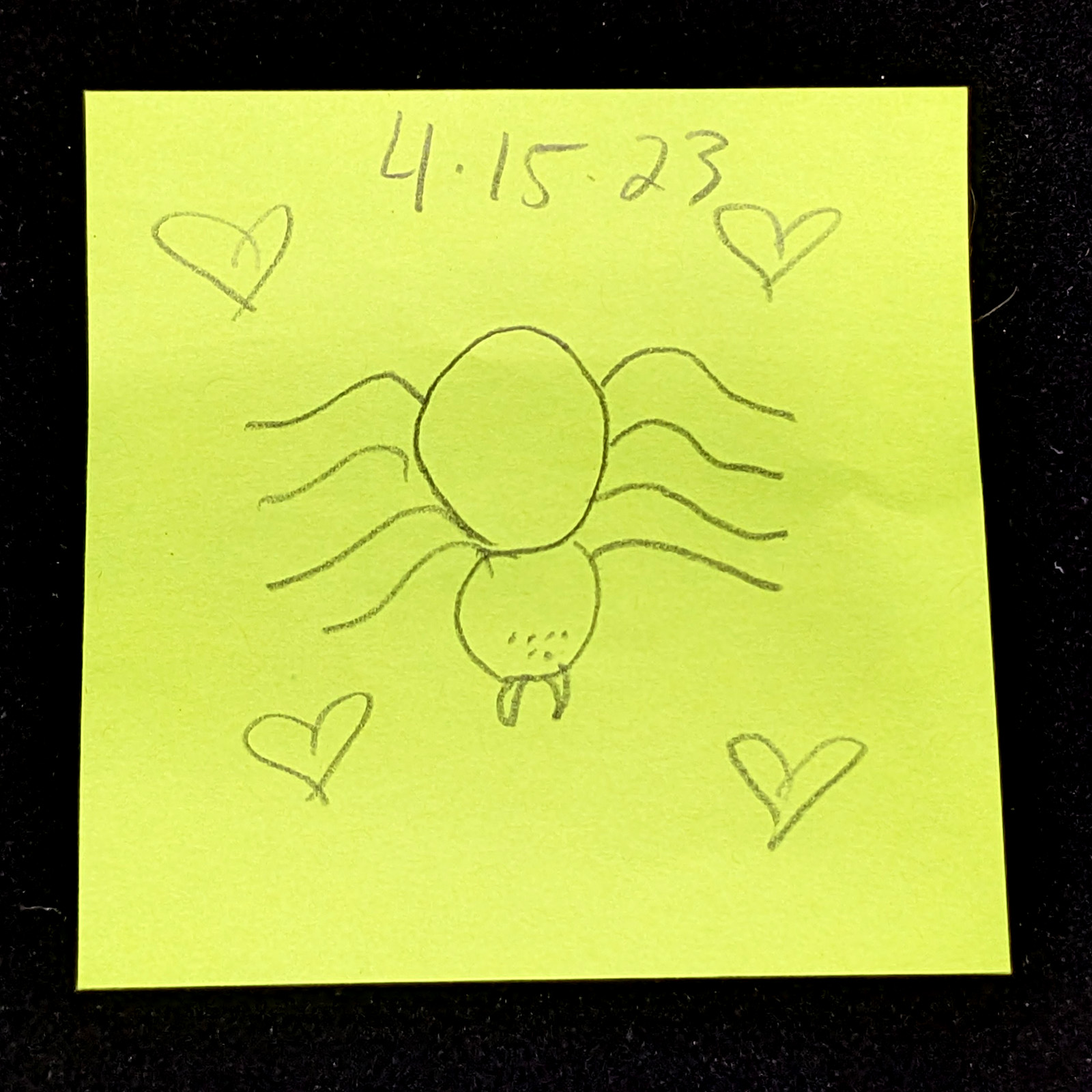 yellow post-it note with handwritten sketch of a spider