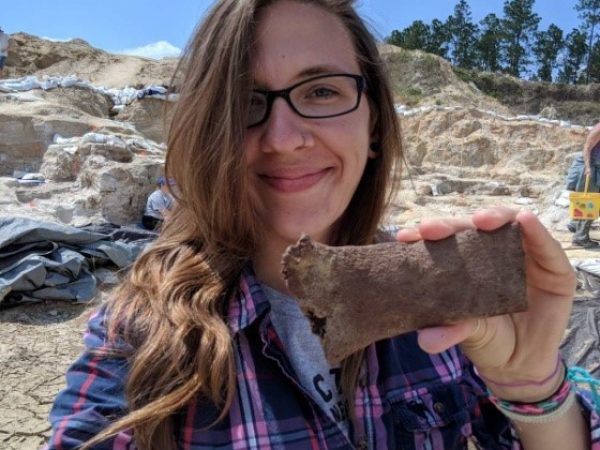 Me holding a piece of the rib of a Gompothere (prehistoric elephant)