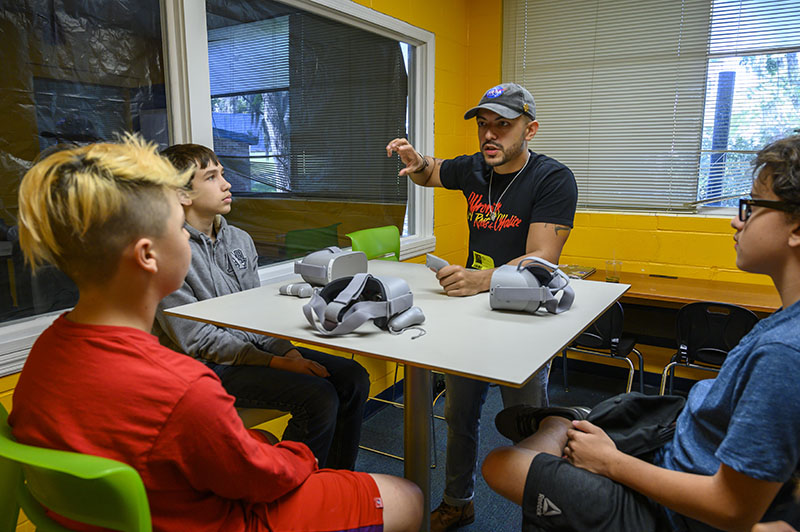 daniel pimentel leads P.K. Yonge students through virtual reality simulation focused on climate change