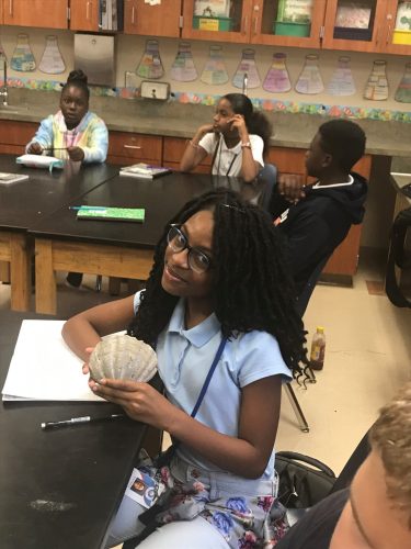 student holding fossil