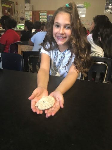 student holds fossil