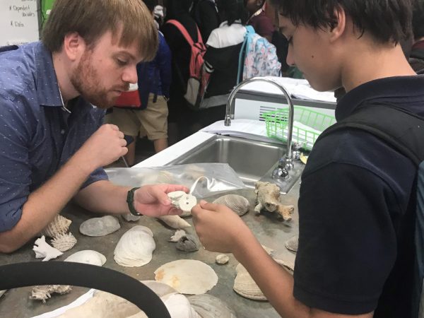 Scientist shares fossils with student