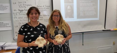 scientist and student posing with hominid 3D skull prints