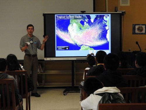 scientist, andrew kren, showing hurricane spagetti models