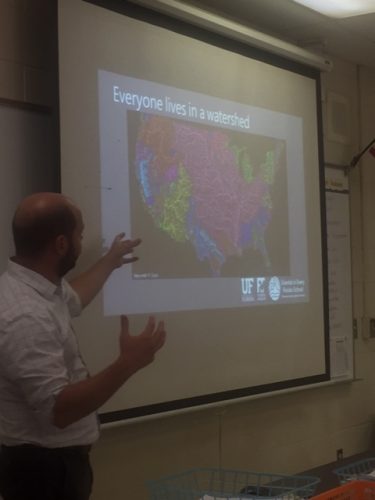 scienitst shows watershed map of United States