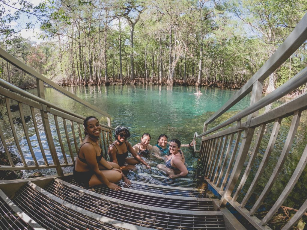 students swim in manatee springs