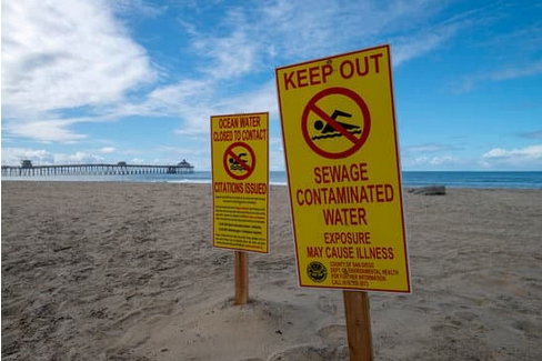 Keep out sign warning of contaminated water. Image by Greg Bulla from Getty Images.
