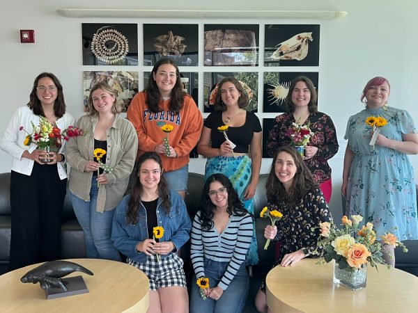 Group shot of the TESI team holding flowers.
