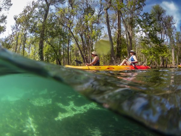 Two people sit on a two person kayak